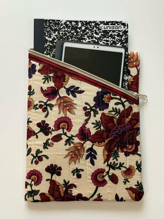 Beige and maroon quilted organizer holding tablet and notebooks