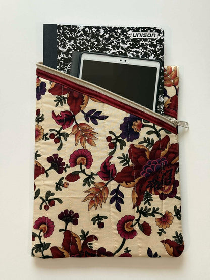 Beige and maroon quilted organizer holding tablet and notebooks