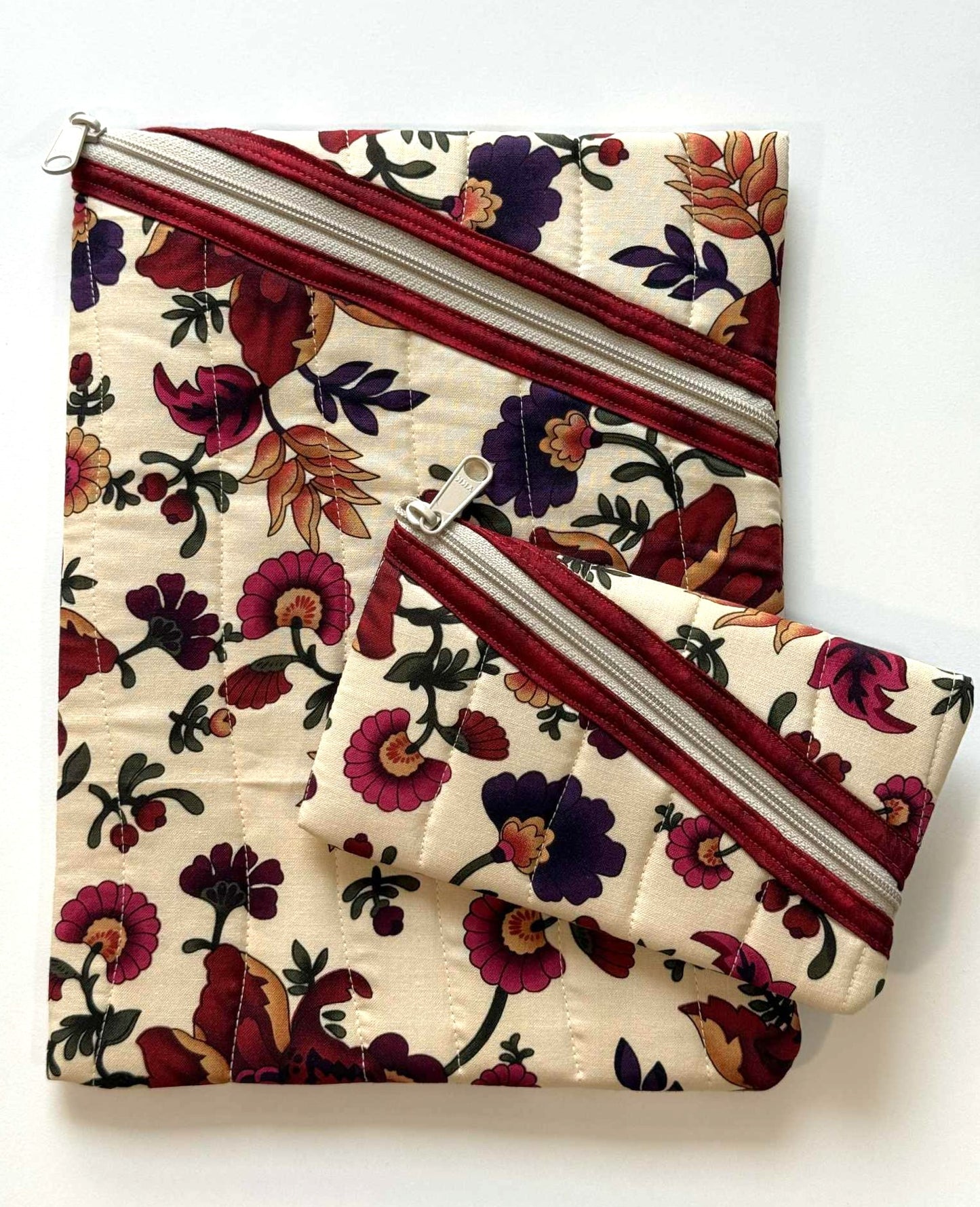Floral quilted zipper pouches with vertical wavy stitching