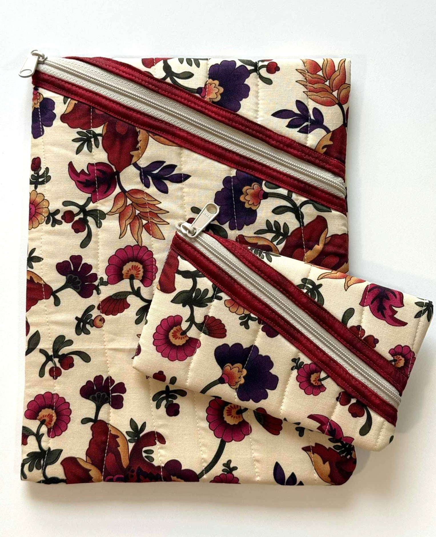 Floral quilted zipper pouches with vertical wavy stitching